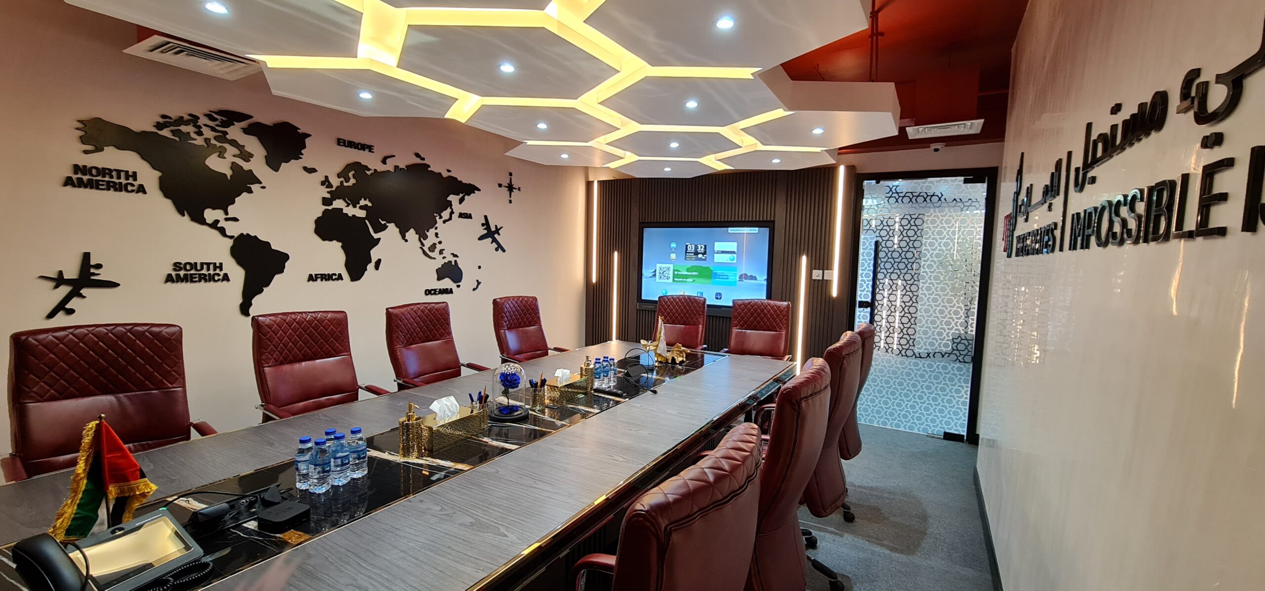 a conference room with red chairs and a map on the wall